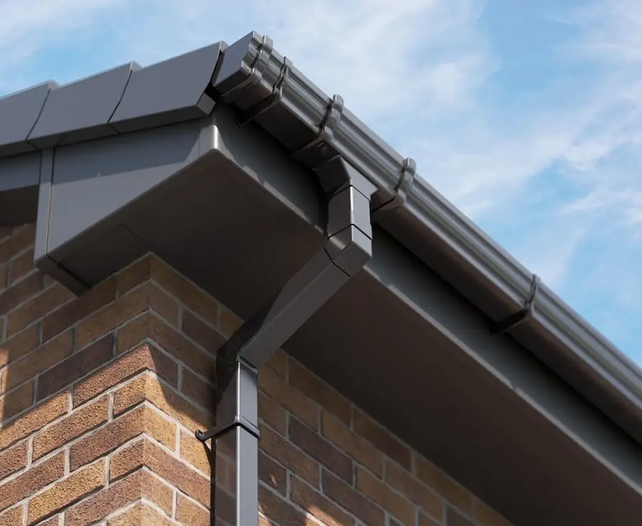 Dark grey fascia, soffit, gutter and downpipe on a brick wall